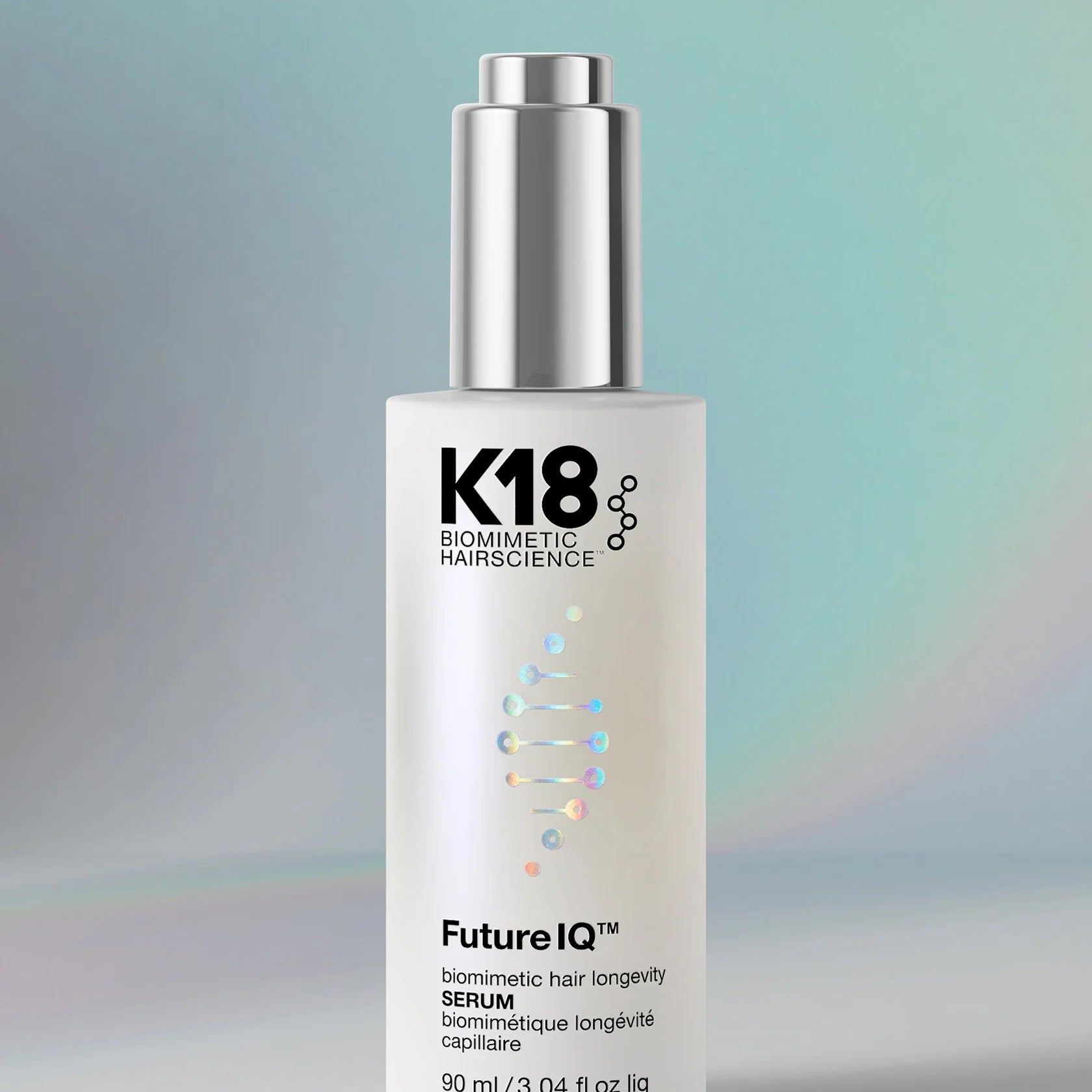 K18 hair serum dropper bottle on a gradient background